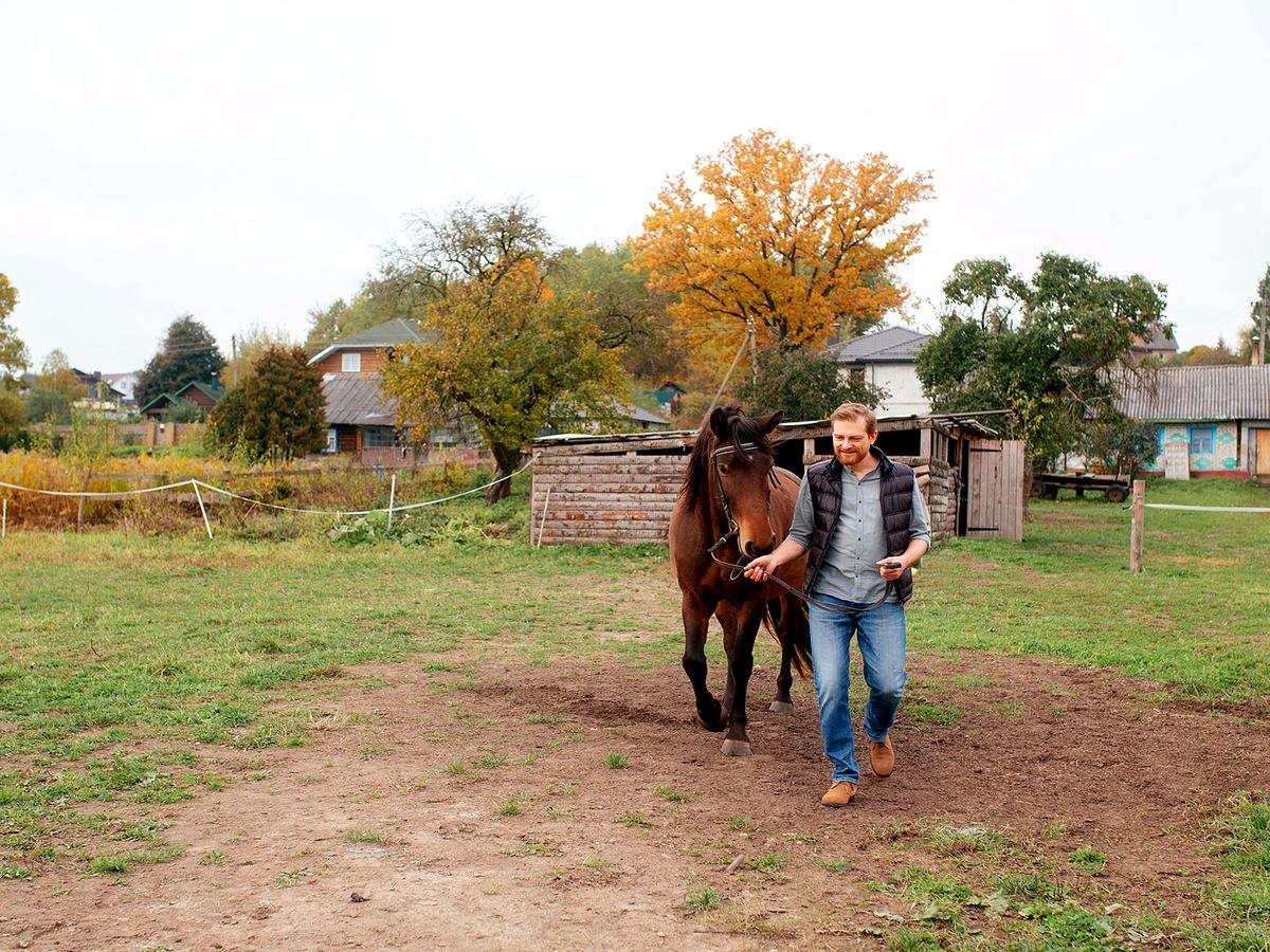 Montanan walking a horse on a rural property